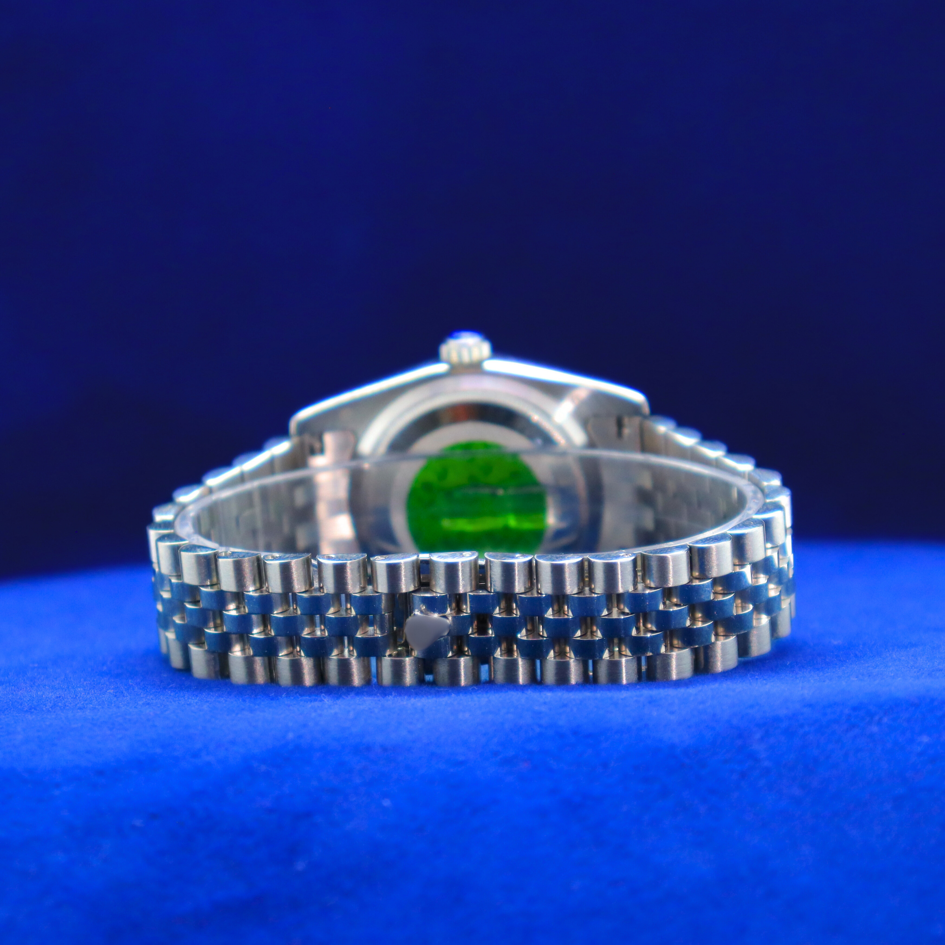 Back view of luxury green dial half iced out custom watch showcasing stainless steel back and refined detail