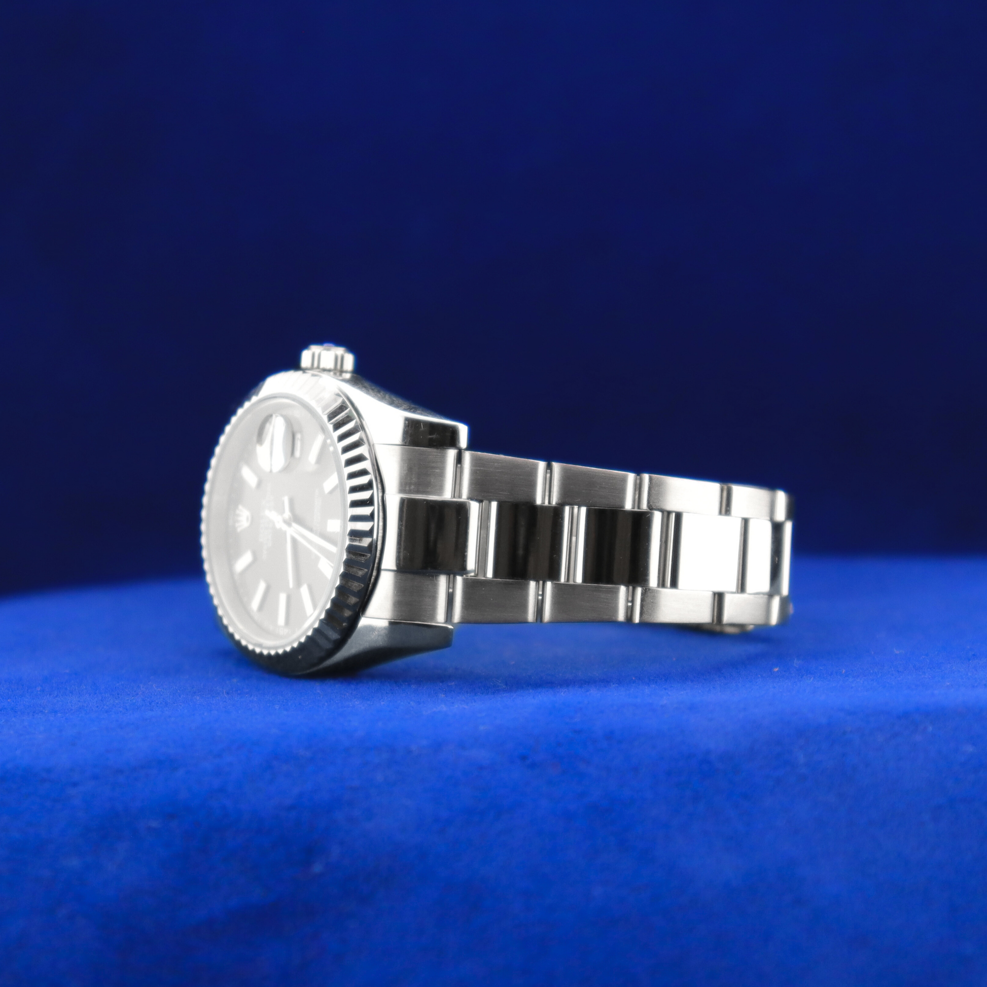 Left side view of luxury sleek black dial half iced out custom watch featuring polished metallic finish