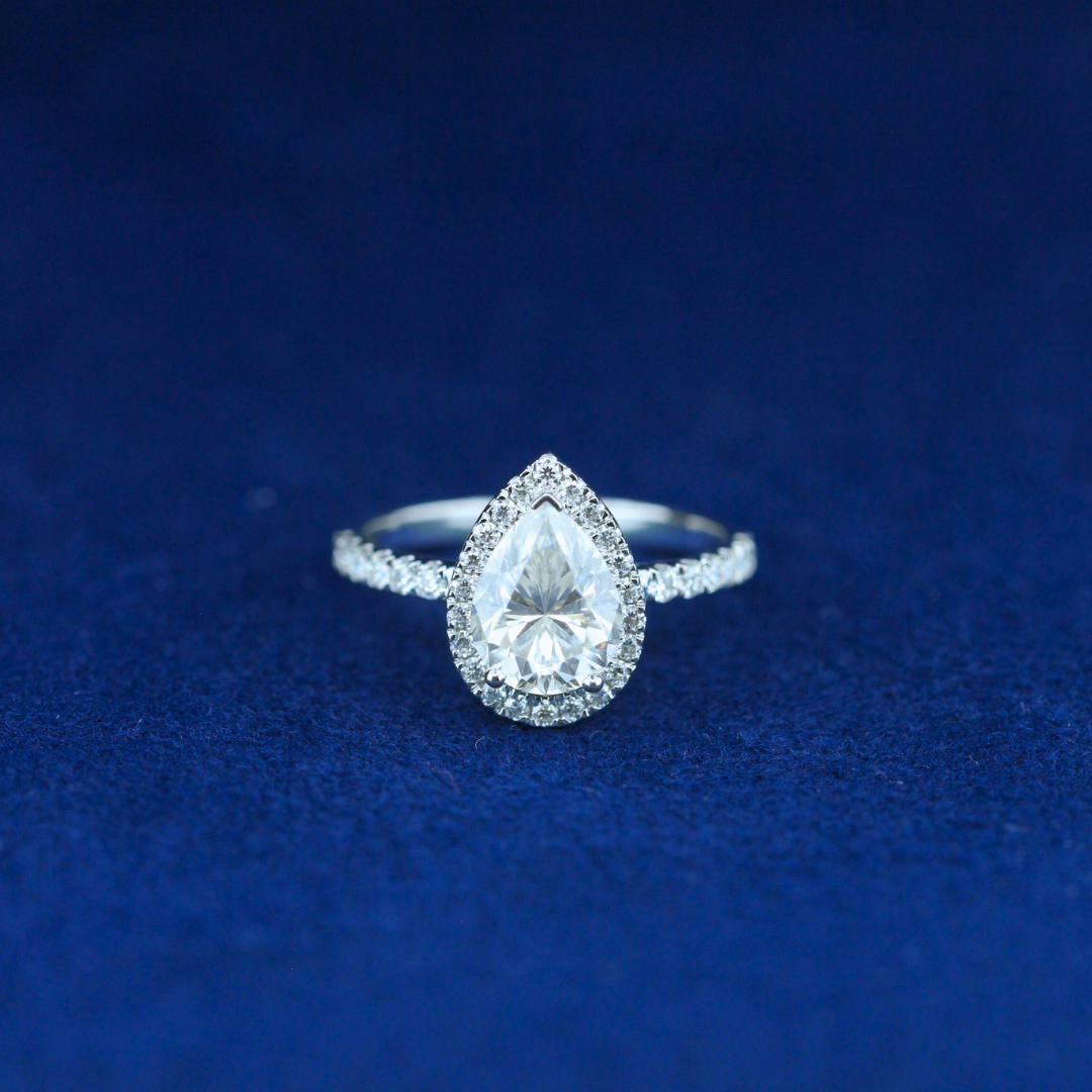A stunning fine jewelry hip-hop pear-cut moissanite diamond ring in 925 sterling silver, featuring an elegant teardrop-shaped diamond with a bold, statement design