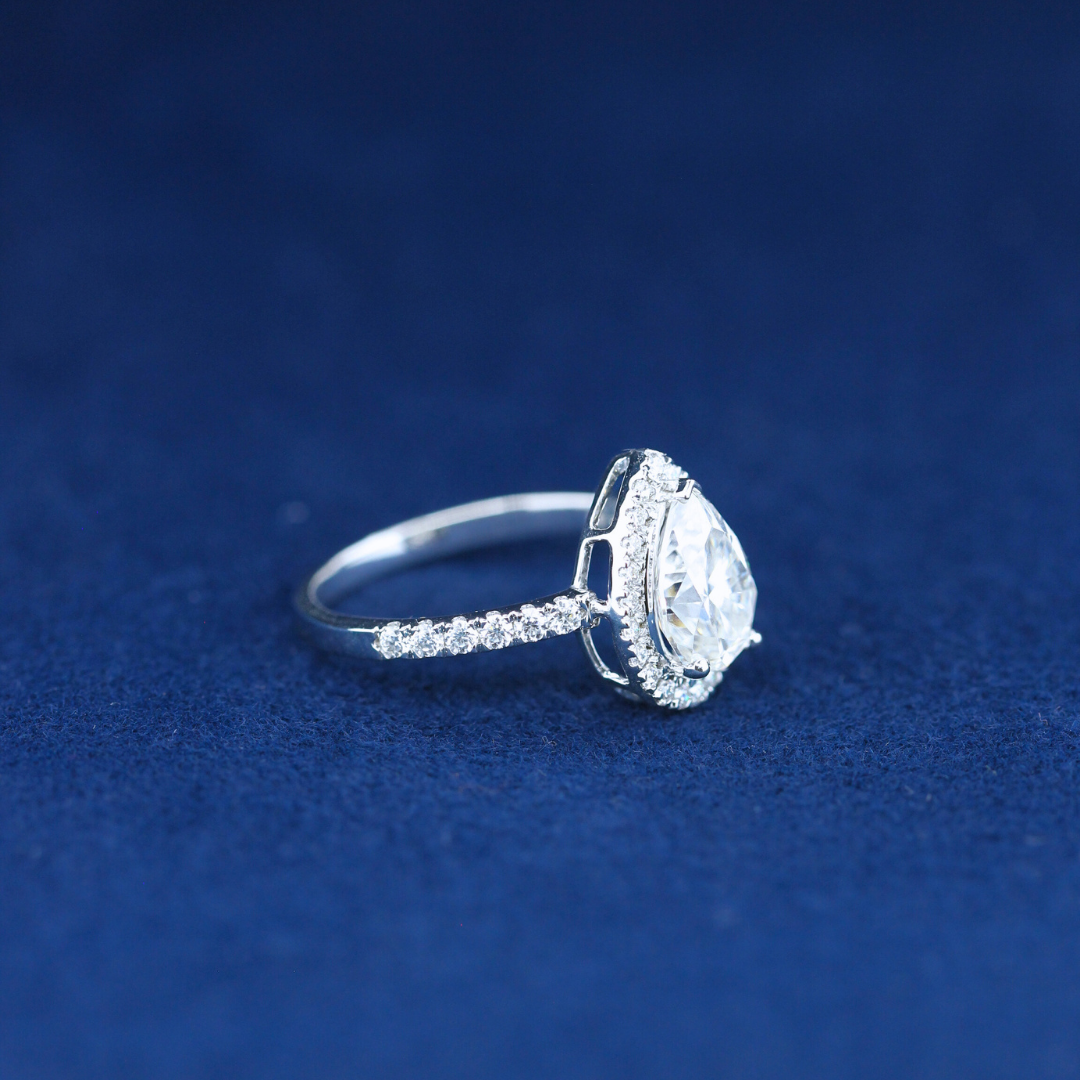 A stunning fine jewelry hip-hop pear-cut moissanite diamond ring in 925 sterling silver, featuring an elegant teardrop-shaped diamond with a bold, statement design