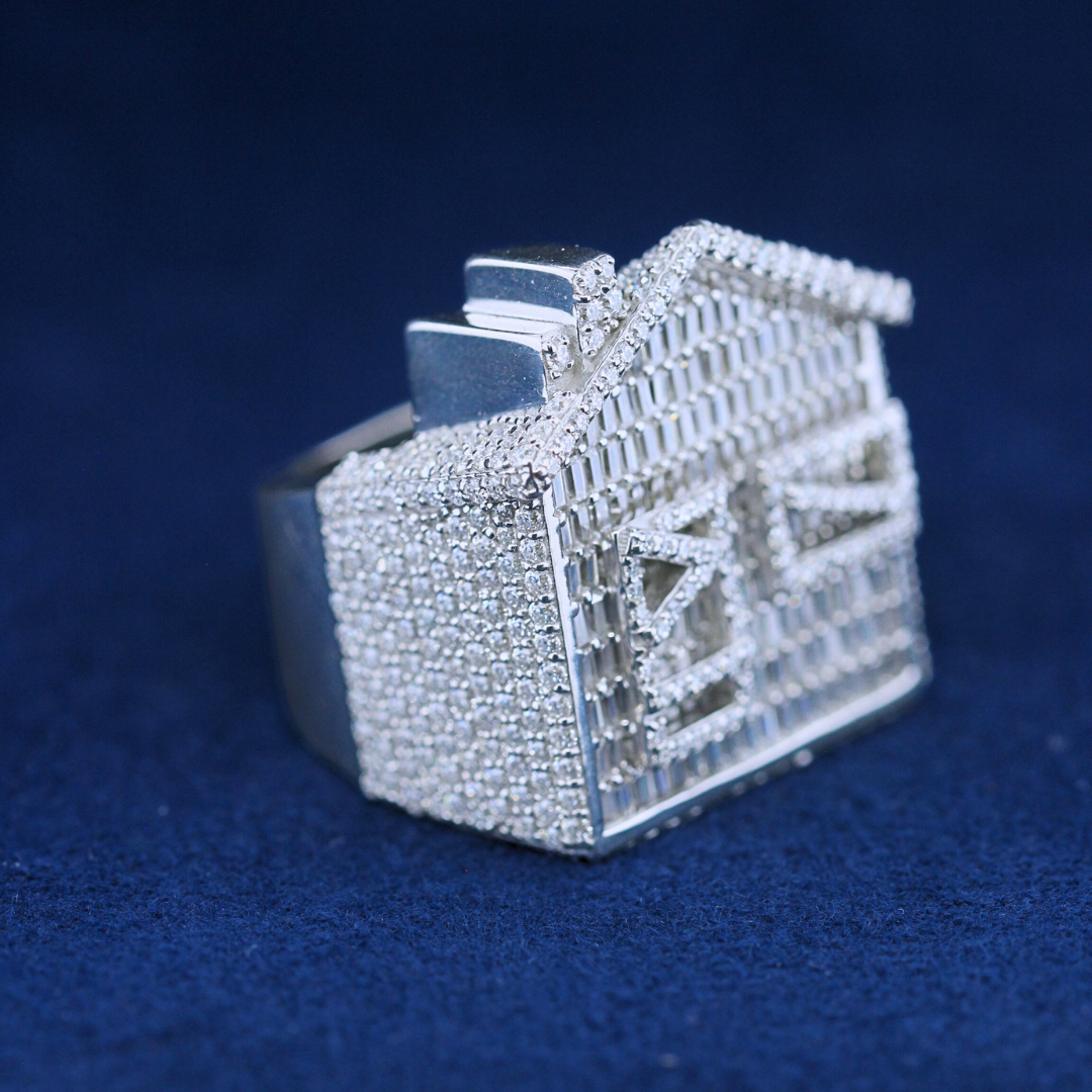 A close-up zoom view of a hip-hop jewelry baguette house ring in 925 sterling silver, emphasizing the luxurious baguette-cut moissanite diamonds and detailed craftsmanship.