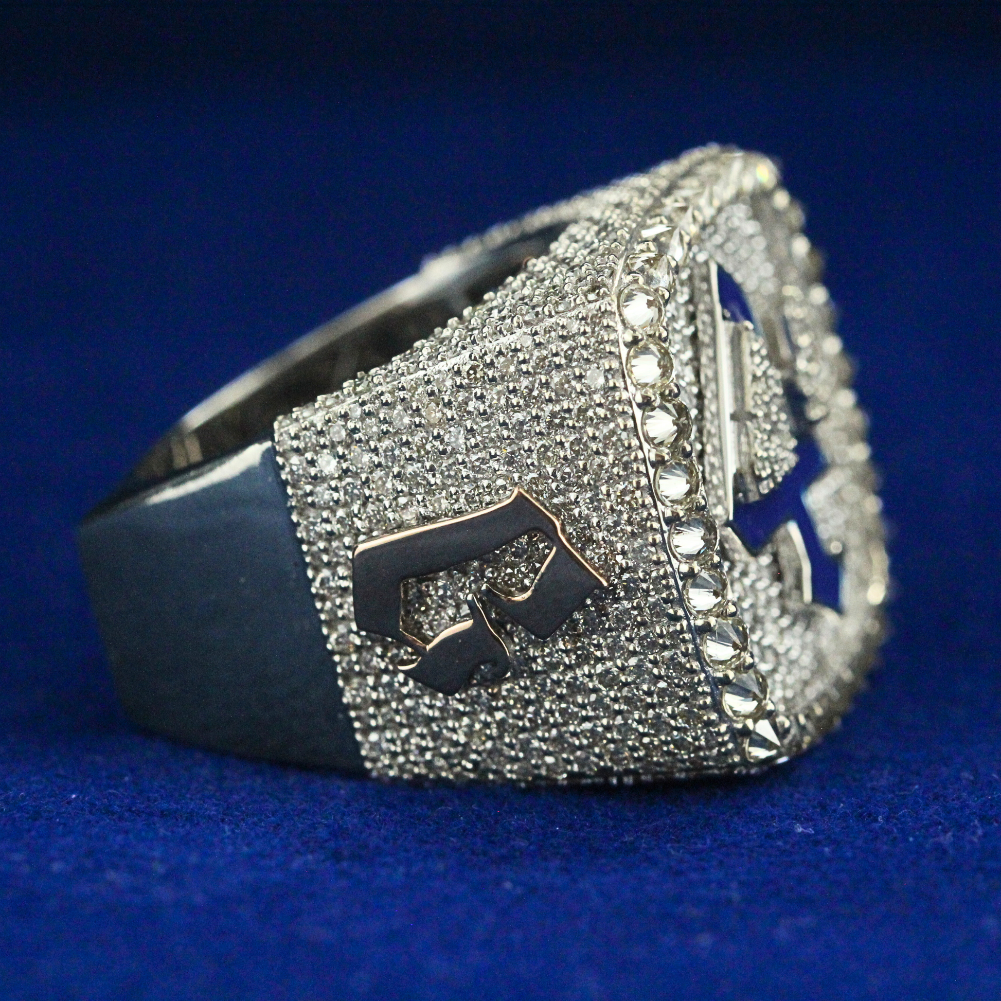 Left side view of the Victory Four Elite Ring, featuring intricate craftsmanship and luxurious moissanite sparkle.