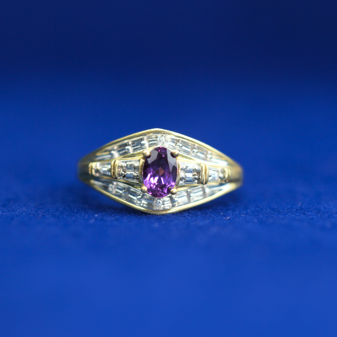 Front view of gold pink sapphire baguette ring in 14K silver with moissanite diamonds – elegant luxury piece styled with half iced out custom jewelry.
