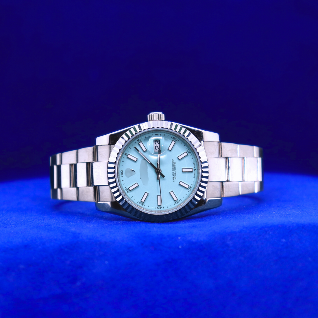 Front view of sleek blue dial half iced out custom watch with a clean luxury design and polished silver case

